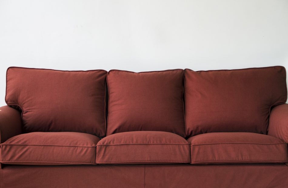 A full frontal view of IKEA's Ektorp sofa, in rust-red wool custom slipcovers made by Comfort Works