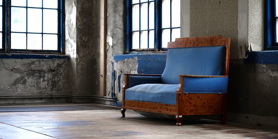 old-blue-couch-in-warehouse