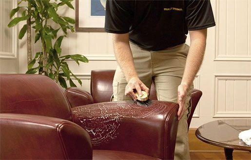 clean brown leather sofa with brush