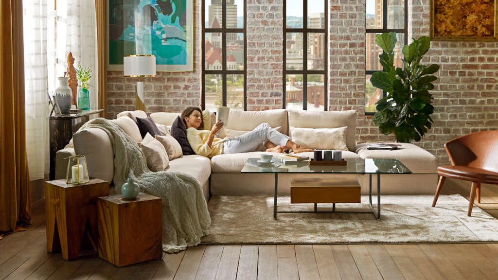 Women lounging on cream-coloured sofa