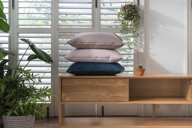 3 cushions stacked on top of desk