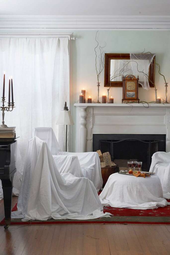 white cloth draped over furniture halloween decor idea