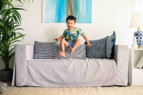 kid jumping in IKEA sofa living room best couch cover