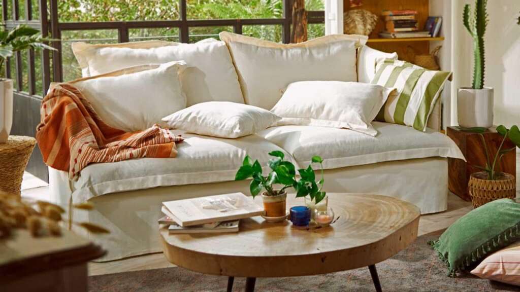 A beige sofa and coffee table in a living room. 