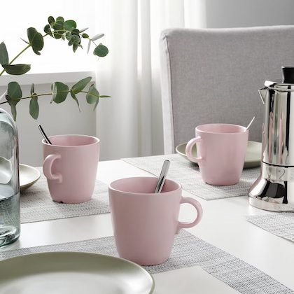 Pink mugs on a dining table. 