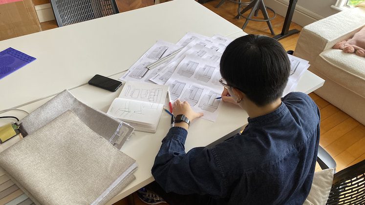 Person working on a white table. 