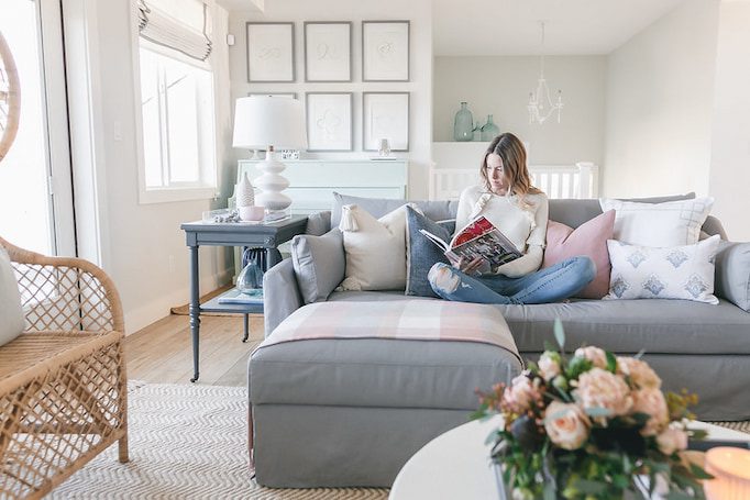 woman-sitting-on-grey-sofa