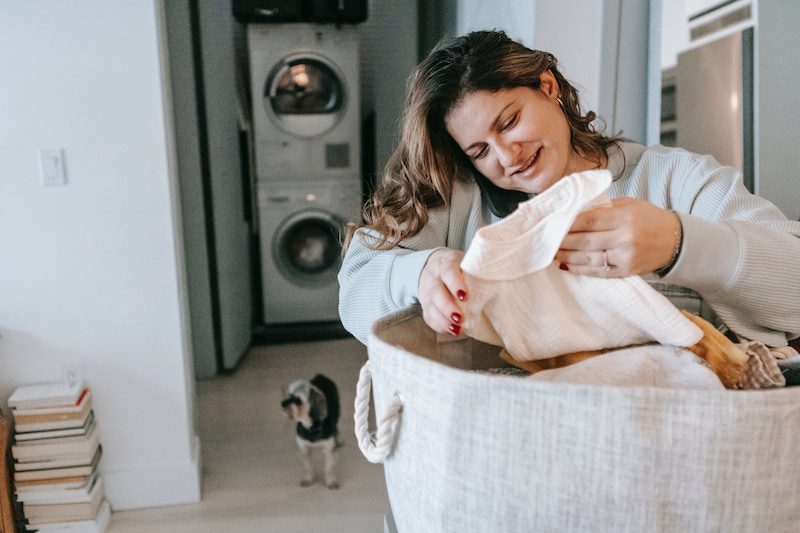 Woman sorting out laundry while on the phone.